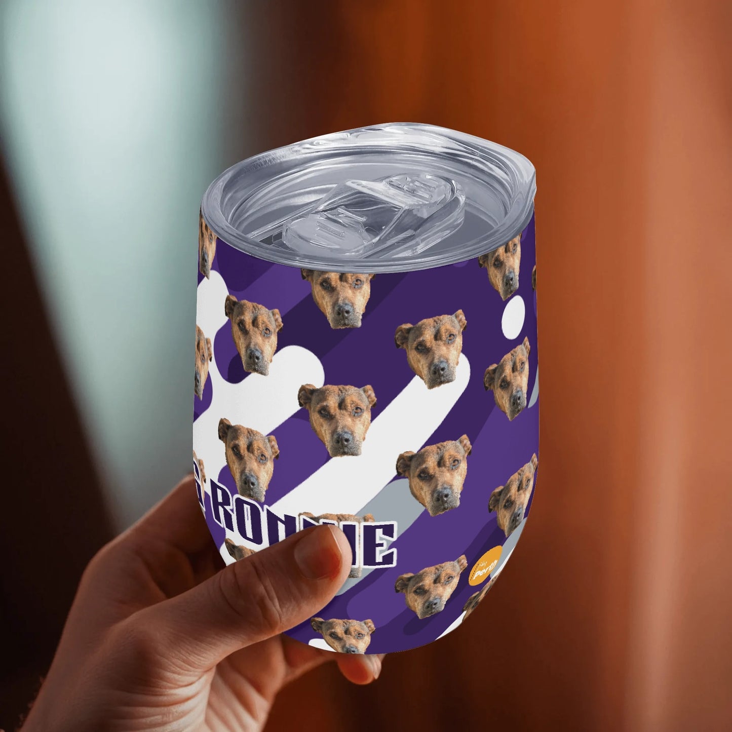 Person holding a purple can with dog pattern and 'Borbone' text