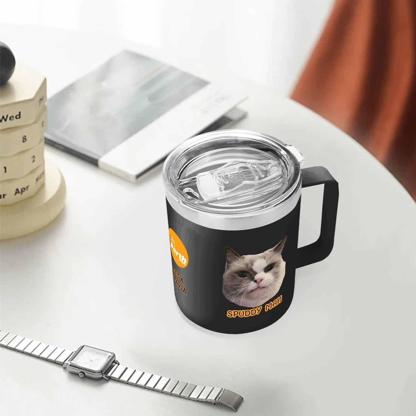 Black mug with a cat design on a white surface