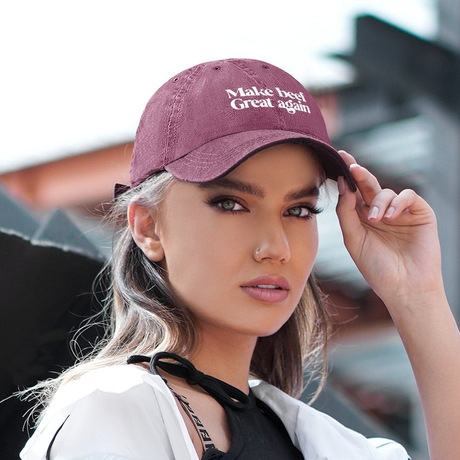 Spunk wearing a cap with Make Beef Great Again, blurred background